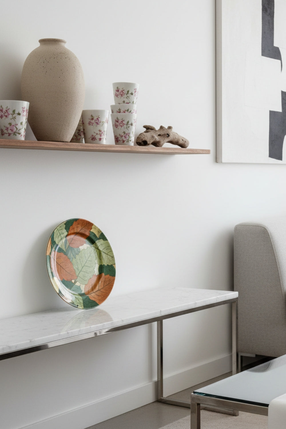 Modern living room with La Casona Edit ceramic vase, floral cups, and a colorful leaf plate
